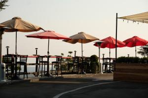 a group of tables and chairs with umbrellas at Hollywood Hills Hotel in Los Angeles