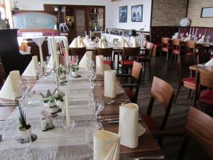 a dining room with a long table and chairs at Hotel Krone in Haigerloch