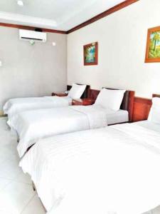 Giường trong phòng chung tại Hotel Bahtera PT.Pelni