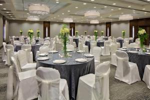 a banquet hall with tables and white chairs at Crowne Plaza - Chicago West Loop by IHG in Chicago