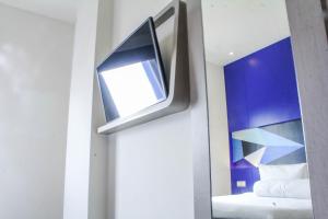 A bed or beds in a room at MD 7 Hotel Cirebon