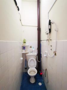 a small bathroom with a toilet and a shower at Bagan Terrace House near to Sunway Carnival Mall, Seberang Jaya in Butterworth