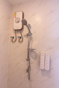 a shower in a bathroom with a blow dryer at Matini Premium @ Klong 1 in Thanya Buri
