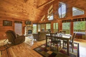 a dining room and living room in a log cabin at Spacious Cubby Bear Cabin in Sevierville