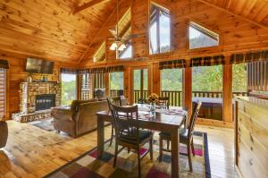 a dining room with a table and chairs in a cabin at Spacious Cubby Bear Cabin in Sevierville