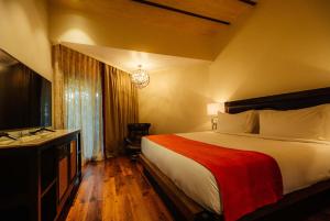 a hotel room with a bed and a television at Holiday Inn Resort Goa, an IHG Hotel in Cavelossim