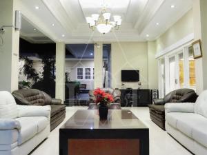 a living room with couches and a coffee table at Wisma Halim Villas & Conference in Cianjur