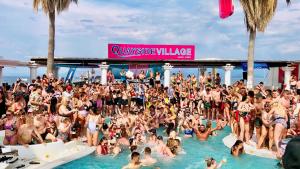 a large crowd of people in the water at a swimming pool at Quayside Village Hotel in Kavos