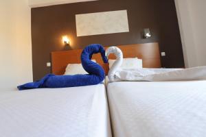 Postel nebo postele na pokoji v ubytování Inn Luanda