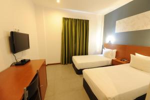 Postel nebo postele na pokoji v ubytování Inn Luanda