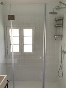 a shower with a glass door in a bathroom at Casa Carmo in Évora