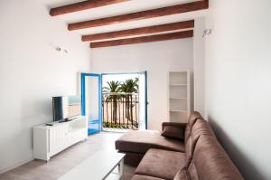 a living room with a couch and a tv at Villasun Spiaggia Centro Storico in Villajoyosa