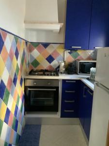 a kitchen with a stove and blue cabinets at Casa Carmo in Évora +8 photos
