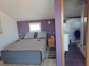 a bedroom with a large bed and a bathroom at Blue View Apartments in Trogir