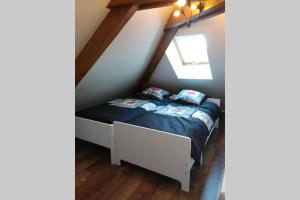 um quarto com uma cama num sótão em Appartement lumineux, calme et panoramique !! em Pouligney