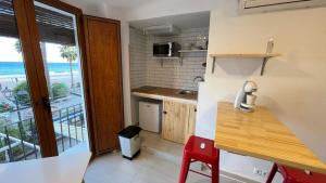 a small kitchen with a view of the ocean at villasun beach studio in Villajoyosa +7 photos
