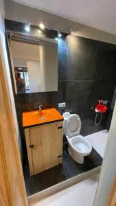 a bathroom with a toilet and a sink and a mirror at villasun beach studio in Villajoyosa