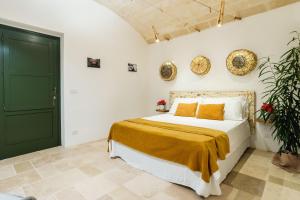 a bedroom with a bed and a green door at Sorelle Barnaba Country House in Monopoli +118 photos