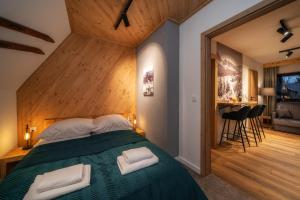 Postel nebo postele na pokoji v ubytování Tatrzańska Miejscówka - Apartamenty Centrum