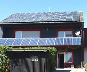 a house with solar panels on top of it at Monteurunterkunft Haus Barbara Pirmasens in Pirmasens