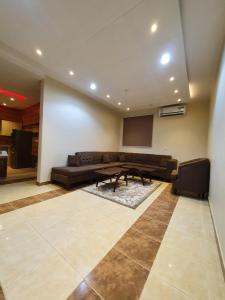 a living room with a couch and a table at لاكازا للشقق الفندقية - La Casa Apartments in Riyadh
