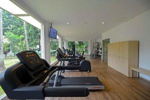 a gym with a row of exercise bikes in a room at Discovery Ancol in Jakarta