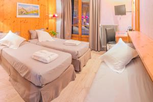 Postel nebo postele na pokoji v ubytování ALPAZUR Val Cenis + 25 fotografií