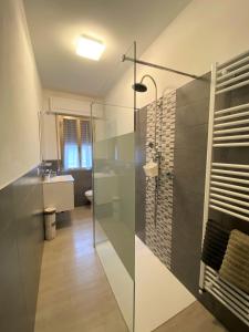a bathroom with a glass shower and a sink at Casa Matì in Altedo