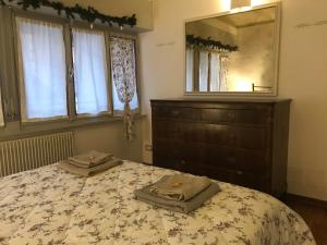a bedroom with a bed with a dresser and a mirror at Che piacere! Udine in centro col posto auto in Udine