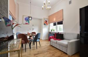a living room with a couch and a table at ShortStayPoland Górskiego (B33) in Warsaw