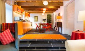 a kitchen and dining room with orange accents at Kentmere Hall Bank Barn in Kentmere