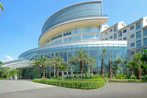 a large building with palm trees in front of it at Discovery Ancol in Jakarta