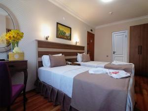 A bed or beds in a room at Sembol Hotel