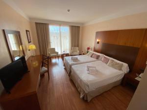Postel nebo postele na pokoji v ubytování Hotel Montera Plaza