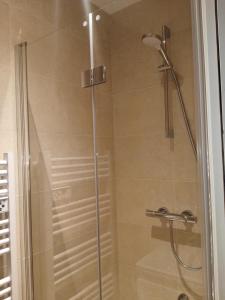 a bathroom shower with a glass shower door at DELARNOR - Confort et sérénité in Saint-Quentin