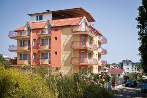 a building with balconies on the side of it at Guest House Villa Rose in Primorsko