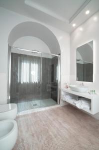 a bathroom with a shower and a toilet and a sink at Isola Polvese Resort in Castiglione del Lago