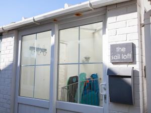 a store with a glass door with a sign on it at The Sail Loft in St Ives