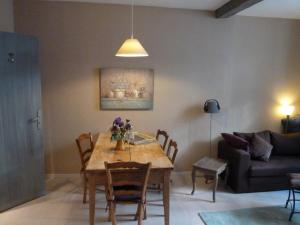 a living room with a table and a couch at L'Oustal du Sentier in Mur-de-Barrez