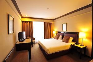 Tempat tidur dalam kamar di Hotel Mimosa