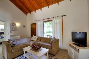 a living room with a couch and a tv at St Lucia Ocean View Lodge in St Lucia