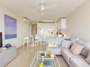 a living room with a white couch and a table at San Agustin Beach Apartments in San Agustin