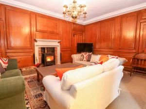 a living room with two white couches and a fireplace at Enterprise House in Bury Saint Edmunds