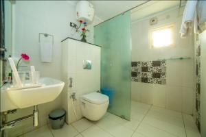 a bathroom with a toilet and a sink and a shower at HILL VIEW JUBILEE HILLS in Hyderabad