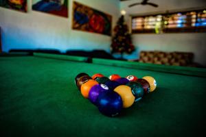 a pile of billiard balls on top of a pool table at Pousada Praia de Bombinhas in Bombinhas
