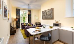 a kitchen and a living room with a couch at Larna Place in Ambleside
