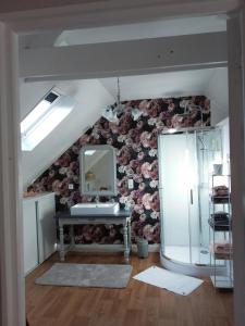 a bathroom with a sink and a mirror on a wall at Les chambres de Marie in Le Saint +10 photos