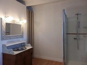 a bathroom with a sink and a mirror at Les chambres de Marie in Le Saint