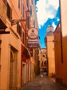 an alley with a sign on the side of a building at Hotel Ristorante Garibaldi in Frosinone