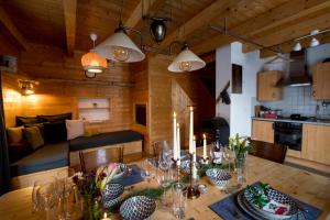 a dining room with a table with candles on it at Naturpark Hütte Mandl, Biobauernhof & Hüttenurlaub in Sankt Lambrecht